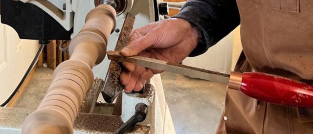 Woodworker Jeff Turner shapes the black walnut on a lathe.